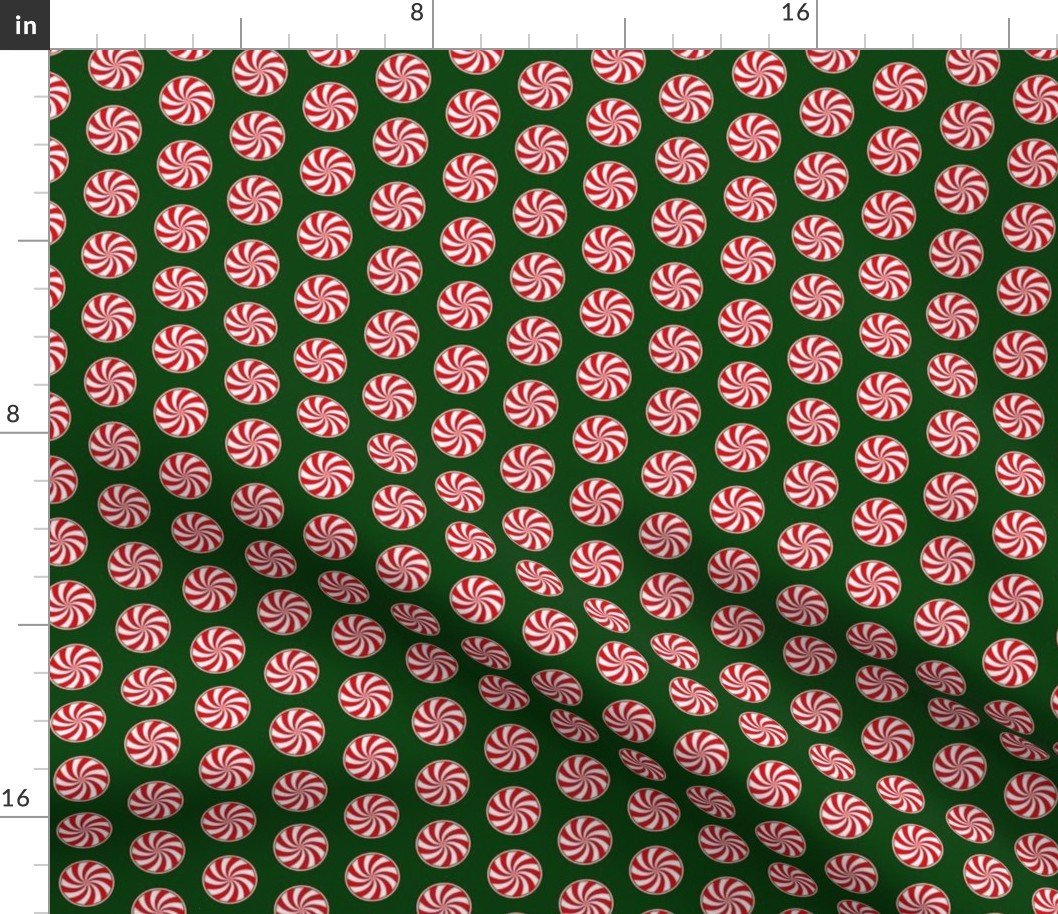 Red and White Peppermint Christmas Candy Swirls on Forest Green Fabric